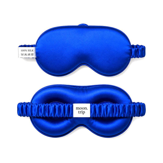 blue silk sleep masks with 'moon trip' branding on a white background